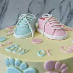 A close-up of the incredibly detailed fondant baby shoes. I love making these tiny toppers; they are the perfect keepsake from a special celebration.
