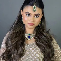 This bride's look is all about royal elegance, with a strong pose and makeup that commands attention.