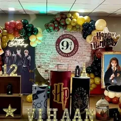 A closer look at the detailed props for a Harry Potter party, including themed pedestals, a silhouette of the Sorting Hat, and a portrait of Hermione Granger.