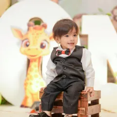 A quiet, happy moment amidst the birthday fun. This candid shot shows the birthday boy sitting calmly, taking in all the celebration around him.