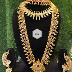 Another view of a traditional temple jewellery set, showcasing the beautiful craftsmanship and ruby-colored stones.