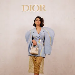 A chic and modern makeup look for a Dior event. The makeup is clean and sharp, complementing the architectural outfit and the iconic Dior branding.