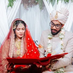 A beautiful, quiet moment during the Nikah ceremony. The bride and groom are looking at their custom red velvet Nikah booklet, a piece I made with so much love for their special day.