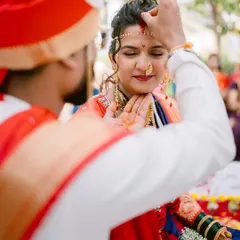 A sacred moment as the groom applies sindoor to the bride's forehead, a key ritual in a Hindu wedding ceremony, captured with intimacy and respect.