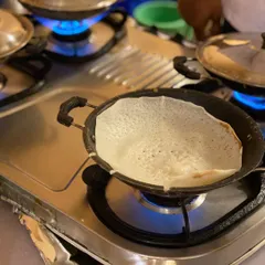 The perfect appam, fresh off the pan. These soft, lacey rice pancakes are a specialty of ours and are best enjoyed hot with a side of delicious chicken or vegetable stew.