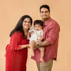 A beautiful family of three, captured in our studio with a simple, warm backdrop. We offer classic family portrait sessions that focus purely on your connection and joy.