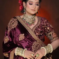 A bride styled in our heavily embroidered wine-colored velvet lehenga. These portraits are a perfect example of a classic bridal look for any MUA's book.