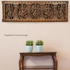 A 36-inch horizontal panel depicting five celestial Apsaras in various dance poses. The natural wood finish highlights the fluid carving and makes it a sophisticated piece of wall art.