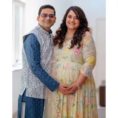 A classic maternity portrait where the couple's hands gently rest on the baby bump. This pose beautifully symbolizes their shared journey into parenthood.