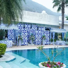 For a chic and modern Mehendi, we transformed this poolside at The Leela Palace in Jaipur into a Mediterranean dream. The decor, inspired by blue pottery, created a stunning contrast against the water, offering a refreshing and elegant atmosphere for a daytime celebration.