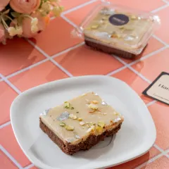 Where tradition meets indulgence. Our Kaju Katli Brownie is the perfect fusion, topping a rich, fudgy brownie with a layer of royal kaju katli, nuts, and silver varq.