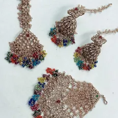 A vibrant multi-colored beaded set, perfect for a fun mehndi or haldi function. This set includes a maang tikka, jhumkas, and hathphool.