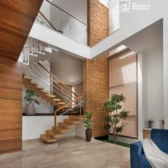 The living area of the Cube House demonstrates how we use vertical space. A double-height ceiling and a large skylight make this compact home feel expansive, while the stone-clad wall adds texture and warmth, connecting the different levels of the house.