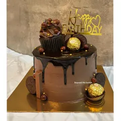 This chocolate overloaded cake is pure indulgence. It's topped with a chocolate cupcake, Ferrero Rocher, Oreos, and has a rich chocolate drip.