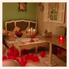 A romantic setup in one of our private corners. The floor is scattered with red balloons and rose petals, with candles providing a soft, warm glow for an intimate dinner.