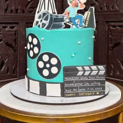 A close-up of the custom clapperboard, which includes details like the production name and the date of the birthday celebration.