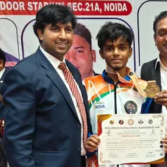 A proud student with his gold medal and certificate at the DDAA Open National Karate Championship. His hard work in kumite and kata training paid off.