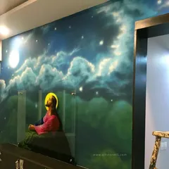 A finished spray paint mural of Jesus Christ against a celestial, starry night sky. This modern religious artwork was created entirely with spray cans, blending colors smoothly to create a serene and atmospheric scene for a private residence.