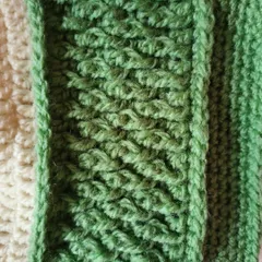 A close-up detail of the Alpine stitch used in the Sheldon beanie. This stitch is created using front post double crochets to make a dense, woven-like fabric.