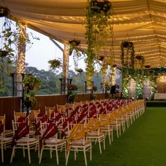 Another perspective of the Sky Terrace seating arrangement, showcasing the artificial grass flooring and elegant chair ties that can be customized to your wedding theme.