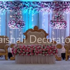 For a touch of royalty, we design stages with grand seating and hanging floral chandeliers. The combination of soft drapes, dramatic lighting, and rich florals creates a luxurious ambience.
