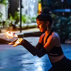 Kneeling with fire lamps, I feel grounded and powerful. Each movement in a fire performance is intentional, blending dance with the elemental force of fire for a captivating show.