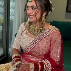 A side view of the dreamy bridal hairstyle, showing the beautiful placement of the dupatta and the elegant bun.