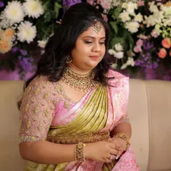This client looks like a doll in her pastel pink and green saree for her engagement. The custom-designed blouse with intricate embroidery adds a touch of glamour to her look.