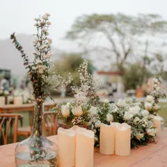 A close-up of the elegant table decor, featuring white flowers and candles. We believe in capturing the small details that contribute to the overall beauty and atmosphere of the wedding.