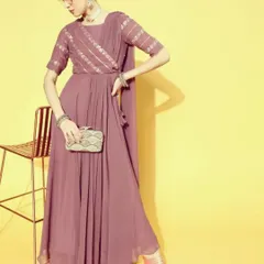 This mauve saree-dress is a modern, hassle-free alternative to a traditional saree. It is a single piece with a pre-draped pallu, making it incredibly easy to wear while still looking elegant.