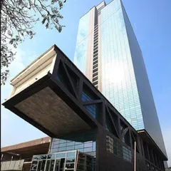 This perspective of The Ruby showcases its dramatic cantilevered entrance, a feat of structural engineering. The bold form creates a powerful statement, reflecting the innovative and path-breaking approach we take with our commercial projects.