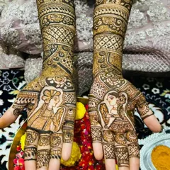 A clear, close-up view of the bride and groom portrait. I focus on getting the expressions and attire just right to make it a personal and memorable part of your bridal henna.