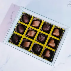 A top-down view of our 12-piece praline collection, showcasing the different shapes and textures of our delicious handmade chocolates.