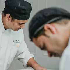 A candid shot of our chefs working late in the catering kitchen. It's a glimpse into the dedication and rewarding hard work that goes into every event we cater.