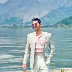 A joyful shot of Mr. Anand by the lake, his smile reflecting his confidence in our bespoke tailoring.