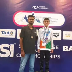 The podium is where hard work pays off. Bryce and his coach pose for a photo at the AOSI Short Course Championships in Bangkok. This moment captures the pride and accomplishment of competing and winning on an international stage.