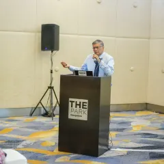We host important industry discussions, like this "Off the Record" session on data security in hospitality. A speaker addresses the audience from a podium branded with our logo.