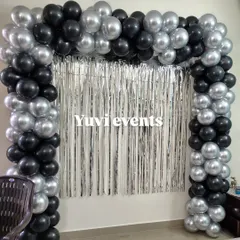Another example of the black and silver balloon arch with a foil curtain, showing how it can frame a space for photos.