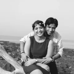 A joyful, candid moment from the same pre-wedding session, presented in black and white. This emphasizes their happy expressions and the connection between them, making it feel classic and intimate.