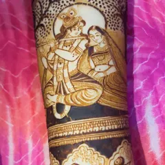 A close-up of our detailed Radha Krishna portrait work on a bride's arm. We take great care in capturing the divine expressions and intricate clothing, making it a spiritual centerpiece for your bridal henna.