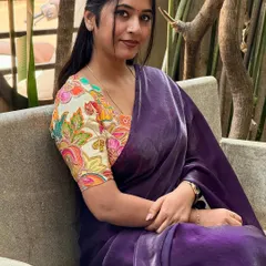 Another portrait from this serene garden shoot. The focus here is on the beautiful printed blouse that adds so much life to the plain saree. It's a perfect example of a chic, modern saree look.