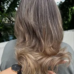 A beautiful ash blonde look with a soft, layered cut. This is a great example of a cool-toned color that looks modern and chic.