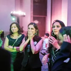 A group of guests caught in a moment of collective shock and amazement. When everyone gasps at the same time, you know you've created a powerful memory.
