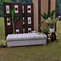 A simple and meaningful photo corner for a spiritual event. I used a traditional wooden screen with auspicious handprints, fresh banana plants, and white floral arrangements to create a spot that is both beautiful and culturally significant.