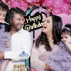 A candid family photograph filled with laughter during a first birthday party. Capturing these unposed, joyful interactions between parents and children is a key part of my family event photography service.