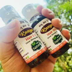 Two small bottles of Kanya Hair Oil, perfect for travel or as a trial size. The dark color reflects the concentration of herbal ingredients.