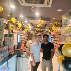 Here we are with the owner after setting up the interior decorations for The New Shop. We placed matching black and gold balloon bunches throughout the store to carry the theme inside and keep the energy high.