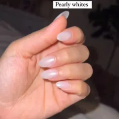 A simple and elegant set of almond-shaped nails with a sheer, pearly white finish for a clean and polished look.