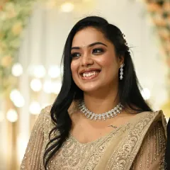 A candid laugh that lights up the room. This bride's Sangeet look features a soft smokey eye and a radiant smile, paired with a glittering gold lehenga and diamond jewelry.