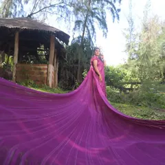 This long, flowing purple saree is a unique option for a maternity or pre-wedding shoot. The extra-long trail adds a dramatic flair to a traditional outfit.